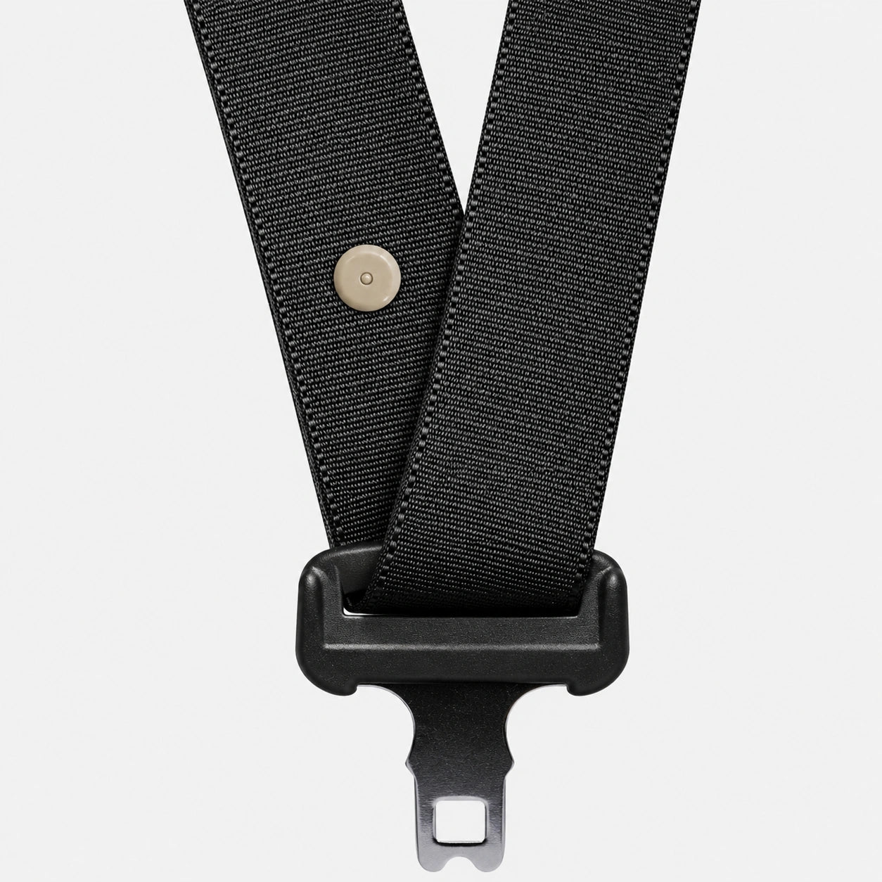 Beige seat belt button stopper installed on black seat belt webbing